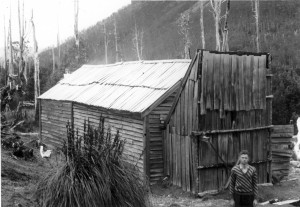 An unsympathetically cropped image of Du Cane Hut, 29 December 1940, with Cathedral Mountain omitted but Charles Smith in the foreground. Ron Smith photo courtesy of Charles Smith.