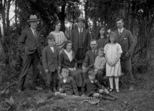 Penney family, Waratah, Tasmania, mid-1920s, with thylacine killer Clem Penney far right at back, and his stripy doormat in the foreground. JH Robinson photo courtesy of Tasmanian Museum and Art Gallery.